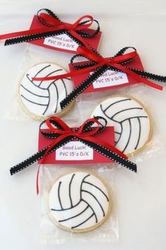 three decorated cookies with red ribbon tied around them