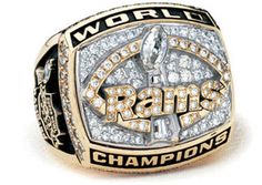 a championship ring with the word world champs surrounded by white and gold diamonds on it