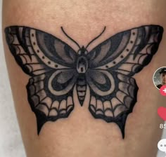 a black and white butterfly tattoo on the thigh