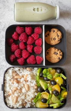 two trays filled with different types of food next to an egg shaker and strawberries