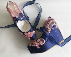 "Navy blue wedge wedding shoes, with dusty pink lace embellishment. Sparkly bridal wedge shoes to add emphasis on your gown and compliment your wedding colors. Stay comfortable on your big day in these elegant bridal wedges. Perfect occasion shoes for outdoor ceremonies, elegant wedding gift, custom heights available. Navy satin wedges are designed with dusty pink embroidered lace. Dusty pink beads and shiny sequins are used on the embroidery and navy blue organza ribbons tie on the front. Gold Prom Shoes Wedges, Dusty Pink Wedding, Silver Bridal Shoes, Bridal Wedges, Navy Blue Wedges, Wedding Wedges, Dusty Pink Weddings, Custom Wedding Shoes, Ivory Bridal Shoes