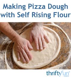 a person is kneading dough on top of a pizza crust with their hands