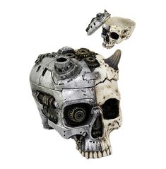 a skull with gears attached to it's head and another metal object in the background