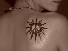 a woman with a sun tattoo on her back