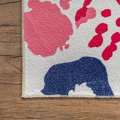 an elephant rug with pink and blue flowers on it