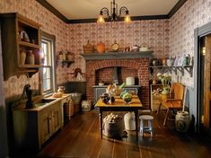 an old fashioned kitchen with wood flooring and wall papered walls, including a brick oven