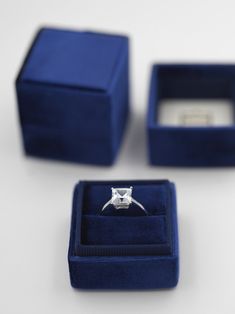 an engagement ring in a blue velvet box