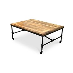 a wooden table sitting on top of a metal frame base with wheels around the legs