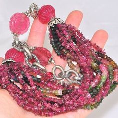 Material: Genuine Sterling Silver (925 silver, 92.5% silver content) Necklace Stone(s): 4 genuine carved pink tourmaline, 6 genuine multicolor tourmaline beaded strands and 6 genuine pink tourmaline chip strands Necklace Length: 18.5 inches Deep: 2 inches Weight: 141.5 grams Clasp: Toggle Stamp/Mark: AKR, STERLING Serial Number: n20587 Tourmaline is a coveted stone that comes in a wide range of colors from black to pink, green and blue. Crystals which display more than one color together are com Necklace Stone, Tourmaline Beads, Watermelon Tourmaline, Tourmaline Crystal, Bead Strand, Strand Necklace, Blue Crystals, Pink Tourmaline, Necklace Length