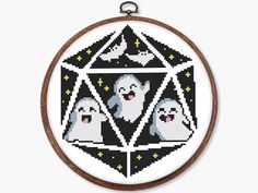 a cross stitch pattern with three ghost faces on it