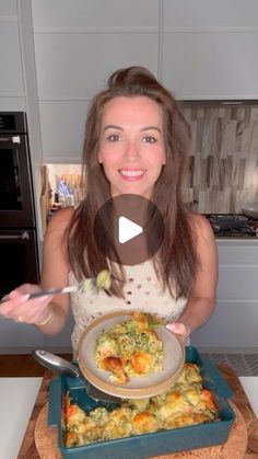 a woman holding a plate with food in it