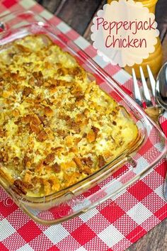 a casserole dish with cheese and meat in it on a red checkered tablecloth