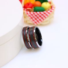 a couple of rings sitting on top of a white table next to some candies