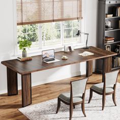 a wooden table with two chairs and a laptop on it in front of a window