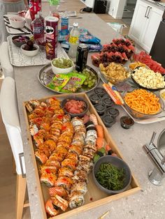 a table filled with food and drinks on it's side, along with other foods