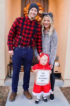 a man standing next to a woman holding a sign