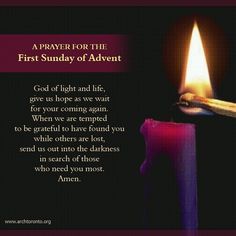 a prayer for the first sunday of adventt with a lit candle in front of it