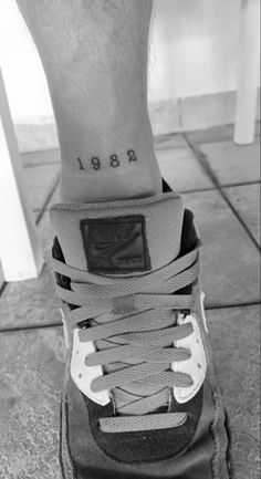 a person with a tattoo on their foot and the words'891'written in black ink