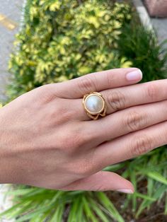 https://www.youtube.com/watch?v=LmsKK0XX-NQ Displayed is a contemporary Mabe pearl and gold solitaire ring. The natural center stone has a beautiful cream color and impressive size. The pearl measures an exact 14.0mm x 14.0mm and is breathtaking. Steadily put, the mabe pearl is held in a secure 14K yellow gold bezel creating a modern and sleek look. To further its beauty, the ring is accented by marvelous gold work that resembles bamboo or a complex structure. The ring is ideal for everyday use Mabe Pearl Rings, Gold Cabochon Moonstone Ring, Pearl Gold Ring, Complex Structure, Gold Pearl Ring, Gold Solitaire Ring, Mabe Pearl, Colombian Emeralds, Emerald Engagement