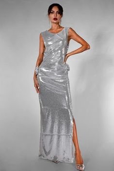 a woman in a silver dress posing for the camera