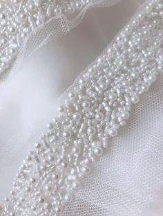 "Beautiful beaded trim, Ideal for bridal, sashes, dolls, hats, ribbon headbands, kid's clothes, bracelets, etc. Listing is for 1.7 Meter. The longest piece is 1.7 meters. Width With Tulle about: 2.75\" (7 cm) Width Of Pearl about: 1.2\" (3 cm) Use for neckline, shoulder belt, pillowcase, dresses, gifts, bags decoration, party dress, curtains, skirt bottoming, home decor and other projects you could imagine. MORE BEADED TRIM: https://www.etsy.com/shop/lacelindsay?section_id=15070868 If you have a Bridal Belt Pearl, Beaded White Bridal Belt For Party, White Beaded Bridal Belt For Party, White Adjustable Wedding Sashes, Adjustable Beaded White Bridal Accessories, White Beaded Adjustable Bridal Accessories, White Beaded Sashes For Party, Adjustable Beaded Headband For Wedding, Couture Beading