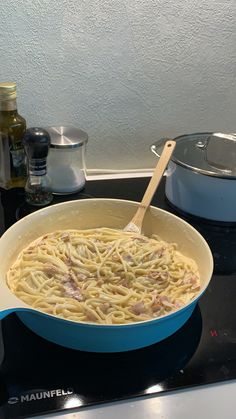 a pan filled with pasta sitting on top of a stove