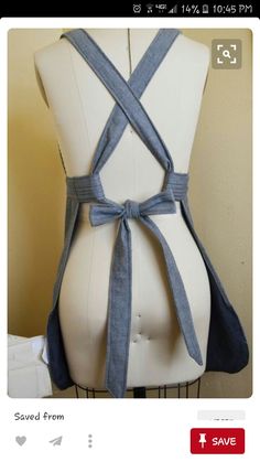 a white mannequin with a blue ribbon tied around it's waist and back