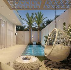 an outdoor living area with a pool and swing chair