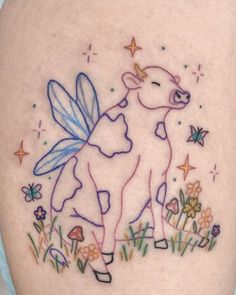 a cow with a butterfly on it's back is shown in this tattoo design