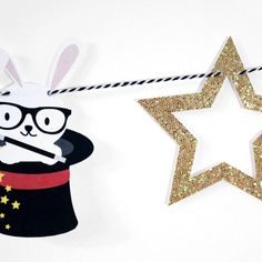 a paper cut out of a magician rabbit and a star hanging on a string