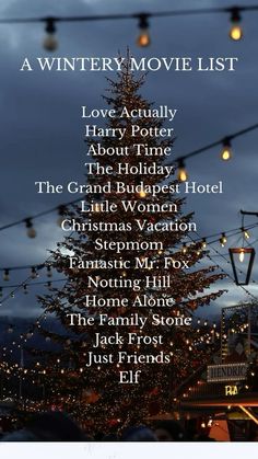 a christmas movie list with lights hanging from the ceiling and trees in the background at night