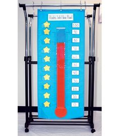 a thermometer is on display in front of a bulletin board with stars and numbers