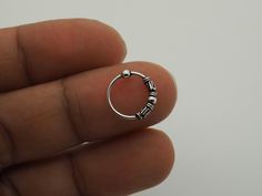 "Nose Hoop, Nose Ring, Hoop Earrings, Ethnic hoops, 22g (0.6mm) Cartilage Silver Small Bali Tribal Bead Hoop Black Piercing Ring 5/16\" (8mm) -------------------------------------------------- Sold individually / Single Piece / 1 Piece. Size: 22 gauge (0.6mm) thick in 5/16\" (8mm) diameter. Made with .925 Sterling Silver Suitable for Cartilage, Upper Ear, Ear Lobe, Helix, Nose Piercing -------------------------------------------------- Shipping Information: Items are shipped worldwide from Thail Silver Nose Ring Aesthetic, Bohemian Nickel-free Round Septum Ring, Adjustable Silver Hoop Septum Ring, Adjustable Sterling Silver Hoop Septum Ring, Adjustable Round Bohemian Nose Rings, Adjustable Hoop Nose Rings Internally Threaded, Adjustable Nickel-free Hoop Nose Rings, Adjustable Sterling Silver Hoop Nose Rings, Adjustable Small Hoop Septum Ring