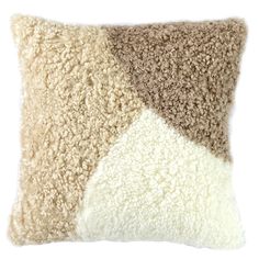 a beige and white pillow with two different colors on the front, one brown and one tan