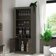 an empty bar with bottles and glasses on the shelves next to a potted plant