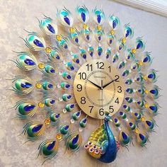 a clock that has peacock feathers on it's face and is displaying the time