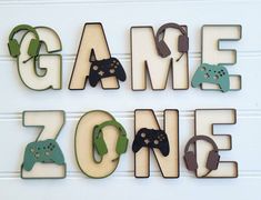 the word game zone is made out of wooden letters with video game controllers on them