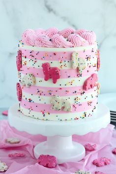 a pink and white cake with sprinkles on it