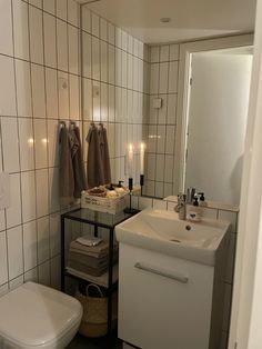 a bathroom with a sink, toilet and towel rack