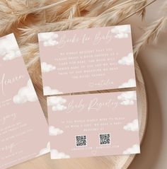 two pink wedding cards with clouds on them