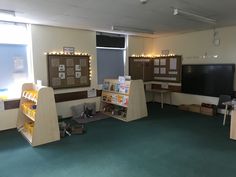 an empty room with several bookshelves and desks