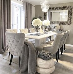 a dining room table with chairs and a chandelier