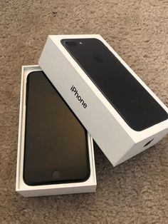 an iphone in its box sitting on the floor next to it's packaging package