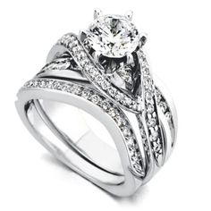 a white gold wedding ring set with two bands and a round diamond in the center