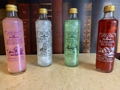 three bottles of liquid sitting on top of a counter