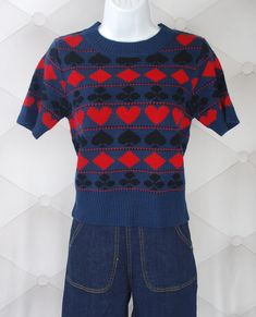 Let's go to Vegas! An authentic reproduction of a 1940s Playing Cards short sleeve sweater with the same fun pattern front and back with black and red suits on a navy background.Made with Vegan Acrylic yarn. Perfect with high-waisted jeans!This sweater has +4" of stretch Size in Inches Size Bust Waist Length Small 32" 28" 20" Medium 34" 30" 20" Large 36" 32" 21" X Large 38" 34" 21" XX Large 40" 36" 22" Red Suits, Black And Red Suit, Star Struck, Red Suit, Navy Background, Short Sleeve Sweater, Short Sleeved Sweaters, Cool Patterns, Sleeve Sweater