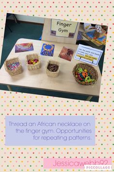 a table topped with baskets filled with different types of beads and cards next to a sign that says finger gym