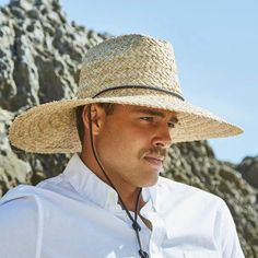 Though not UPF rated, this Scala lifeguard hat features an extra large 5 inch brim for great protection against the sun. It is made of durable raffia fibers that pack and crush well and will stand the test of time. Comes in two sizes with an elastic band liner and includes a leather chinstrap with a spring-locking bead for those windy days on the beach. Dorfman Pacific's new Organic Raffia Straw Lifeguard Hat has the classic look lifeguard hats are known for – cattleman crown and wide, down-sloping brim – all in a naturally harvested, organic raffia straw design you'll love. Crafted to provide ample coverage from the hot sun, this style boasts a 5-inch wide brim that covers not only your face and ears but also the nape of your neck. A handy faux leather toggle chincord is also provided to Beach Lifeguard, Lifeguard Hat, Upf Clothing, Outback Hat, Windy Day, Wide Brimmed, Straw Hat, Hat Sizes, Leather Band