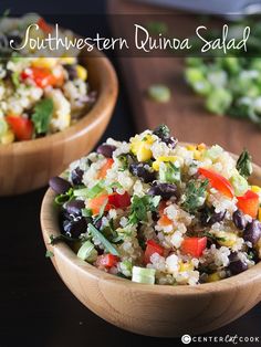 two wooden bowls filled with rice, black beans and veggies on top of a table