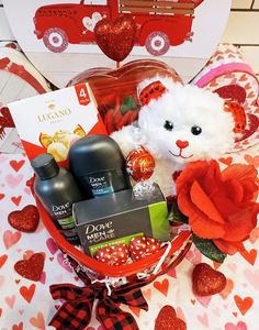 a valentine's day gift basket with a teddy bear, soaps and lotion